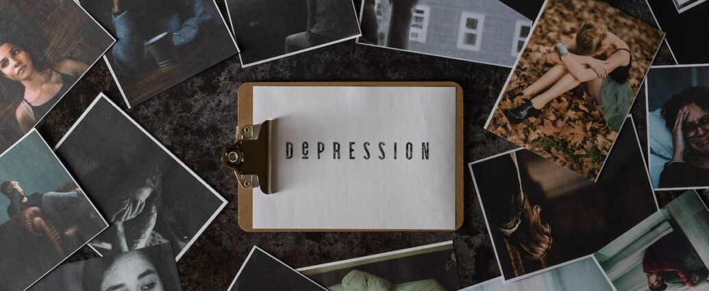 A clipboard with a paper that says depression sits among seasonal depression images.