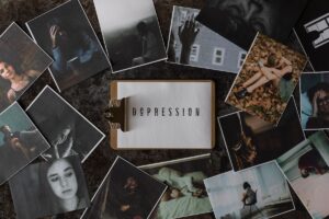 A clipboard with a paper that says depression sits among seasonal depression images.