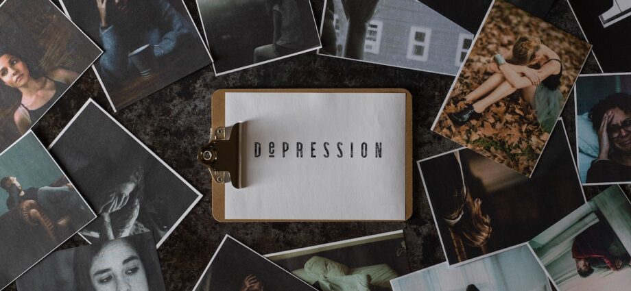 A clipboard with a paper that says depression sits among seasonal depression images.